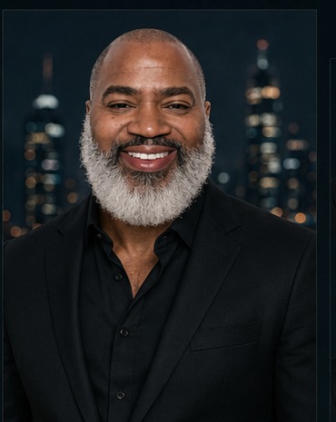 Timothy Thomas, founder of GRAND 410, photographed against the Baltimore skyline at night